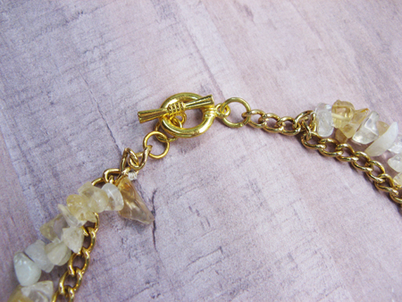 Close up of brass toggle clasp on necklace
