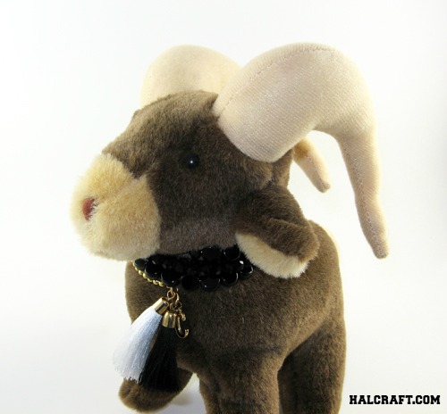 Stuffed animal with beaded collar